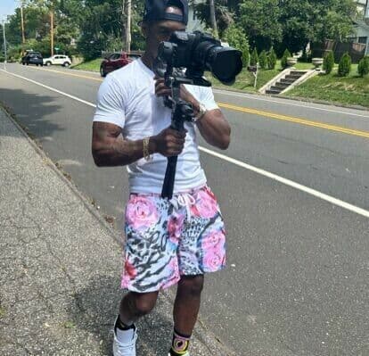 Dumas Holding Camera Front